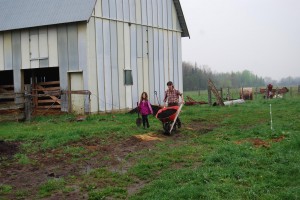 Ali and Erin hauling compost to the trees